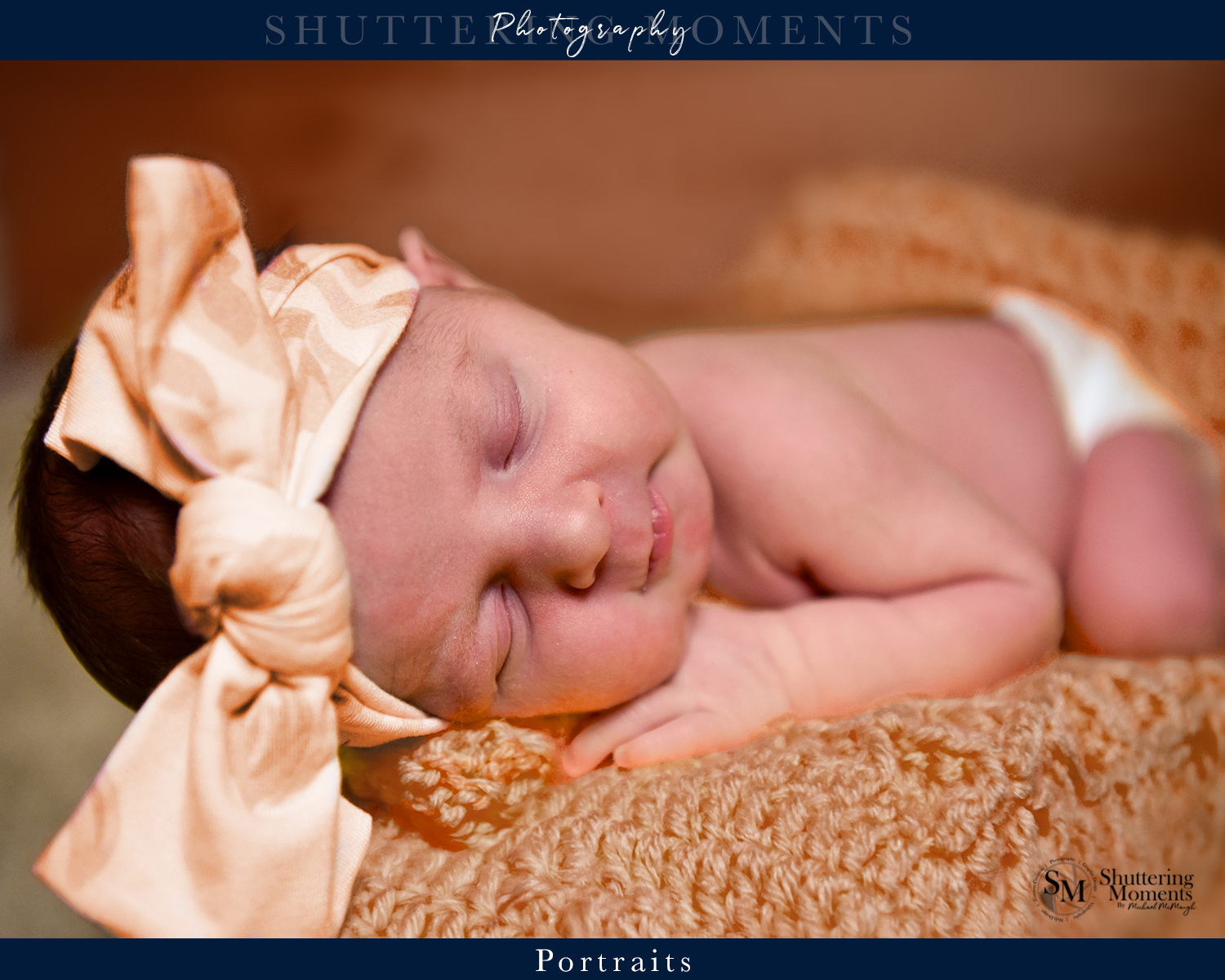 Newborn baby sleeping peacefully on an orange blanket in a cozy, gender-neutral photoshoot.